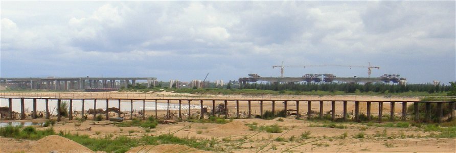 Dinghai Bridge during construction. Note the wooden bridge in the foreground. The Dinghai Bridge is in the background. photo