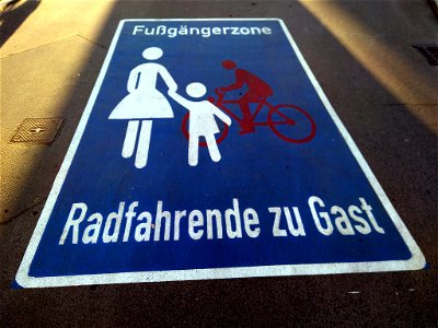 Roadway pictogram "Pedestrian zone cyclists as guests" in the pedestrian zone in Waldemarstraße in Berlin-Kreuzberg, Germany. photo
