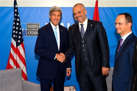 U.S. Secretary of State John Kerry shakes hands with Albanian Prime Minister Edi Rama as Albanian Foreign Minister Ditmir Bushati looks on before a bilateral meeting on September 5, 2014, on the sidel photo