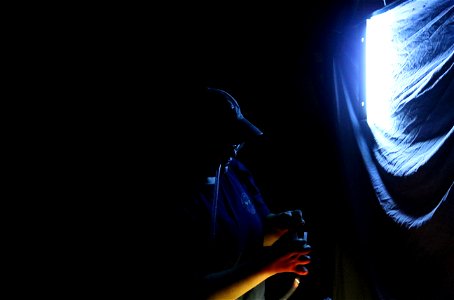 UT student collecting insects from a blacklight using an aspirator