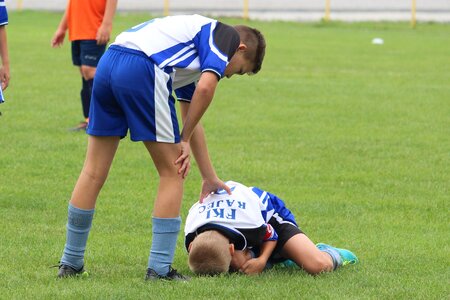 Teammate help footballer