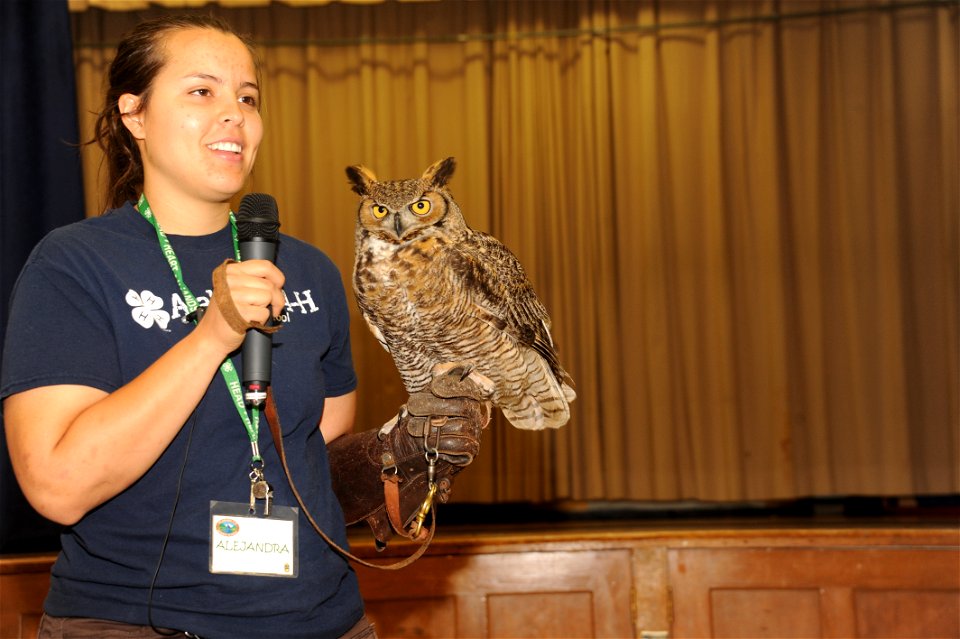 Alejandra Palacio, Alabama 4-H Science School environmental educational instructor, displays a Great Horned Owl to Maxwell Elementary and Middle School students during the Birds of Prey demonstration 