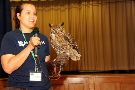 Alejandra Palacio, Alabama 4-H Science School environmental educational instructor, displays a Great Horned Owl to Maxwell Elementary and Middle School students during the Birds of Prey demonstration 