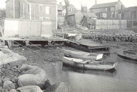 Scene along the river front at Fairhaven, showing a quahaug shanty and several skiffs, which are used in raking the small seed quahaugs from the Acushnet River. Owing to the pollution within the restr photo