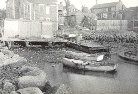 Scene along the river front at Fairhaven, showing a quahaug shanty and several skiffs, which are used in raking the small seed quahaugs from the Acushnet River. Owing to the pollution within the restr