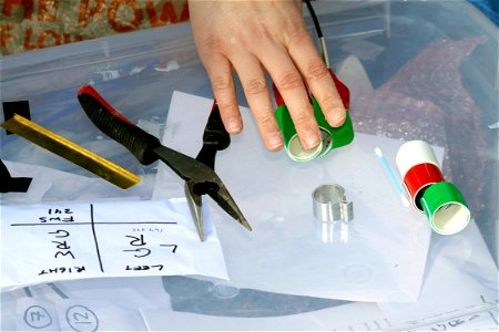 Items are prepared to place an aluminum and colored leg bands and a radio transmitter on the legs of a juvenile Whooping Crane. The colored leg bands, in unique color arrangements on the leg, allow a photo