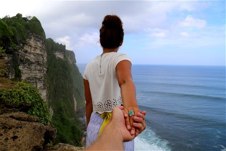 Woman Holding Hands Cliff photo