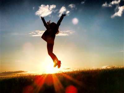 Woman Jumping Sunset photo