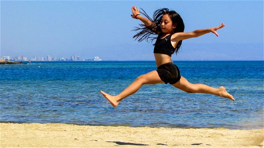 Girl Jumping Beach photo