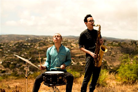 Men Playing Drum Saxophone