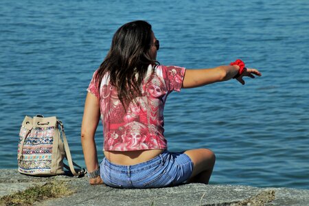 Sitting woman lake photo