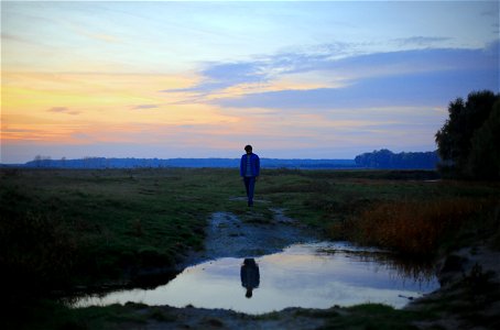 Man standing in front of a Puddle