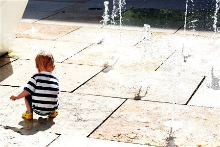 Child Plays With Water Jets photo