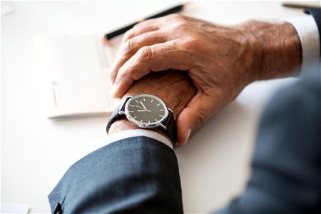 Businessman checking time on hand watch photo