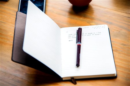 Open leather notebook on a table photo