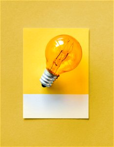 Colorful light bulb on a paper photo