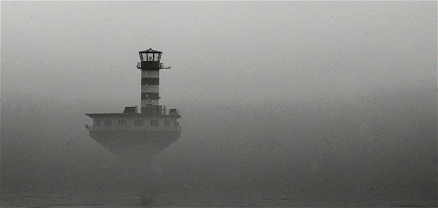 Lighthouse in the mist photo