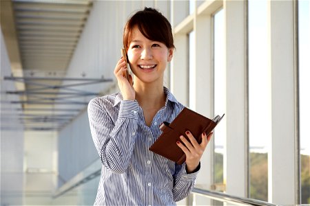 Businesswoman Mobile Phone Notebook