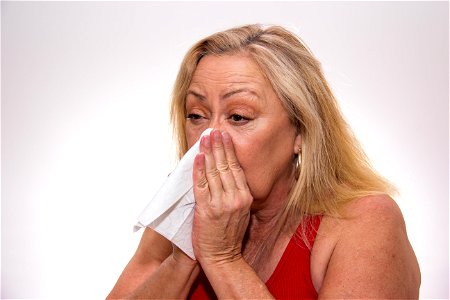 Senior Woman Blowing Nose photo