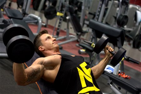 Man Training Muscle Dumbbells