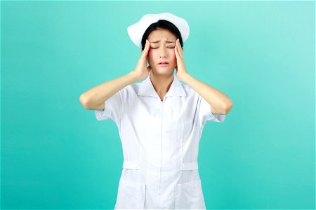 Woman Nurse Headache photo