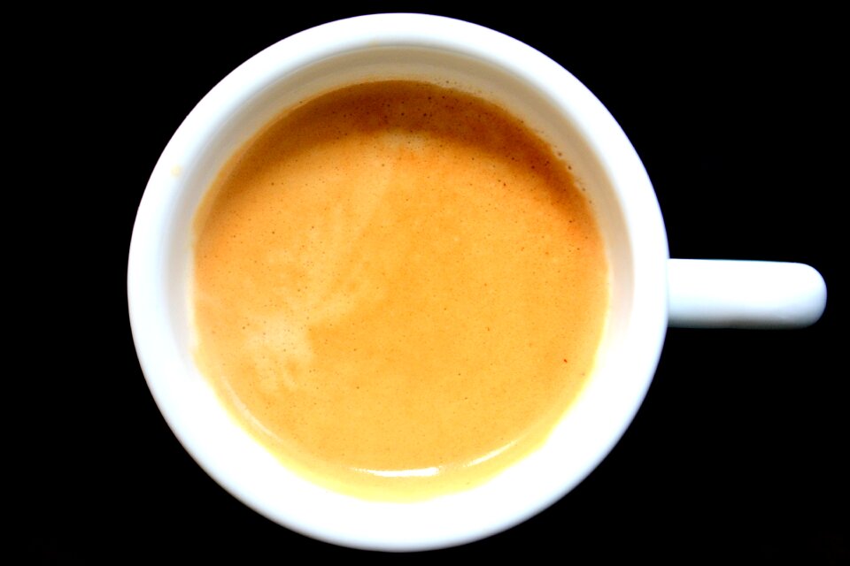 Black background cup of coffee coffee in detail