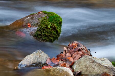 Long exposure autumn stone in the water photo