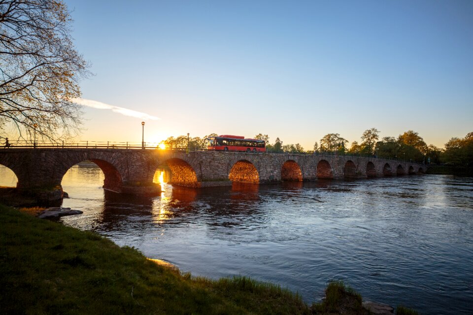 Bus stone arch bridge sunset