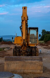 Yellow excavator blade road construction photo