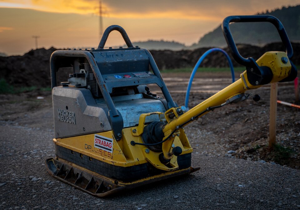 Yellow excavator blade road construction