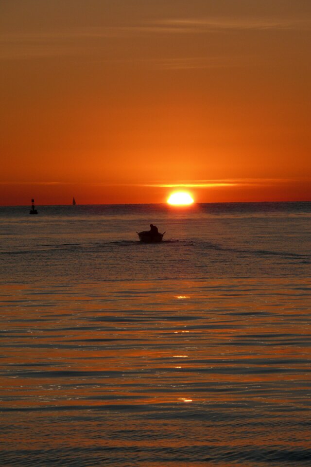 Fisherman sunset sea photo