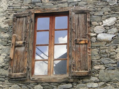 Old window stone house reflection
