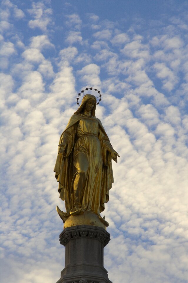 Clouds evening statue of mary