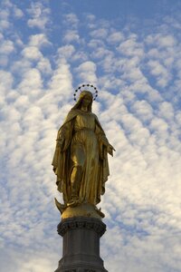 Clouds evening statue of mary