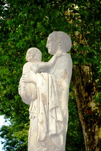 Carrying baby statue stonework photo