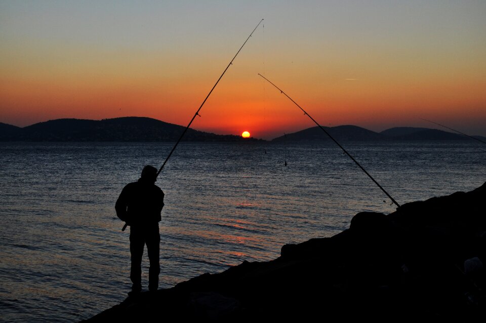 Sunset fishing rod fisherman