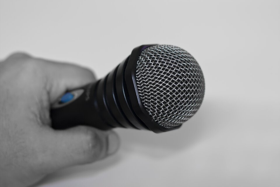 Hand holding microphone speaker sound