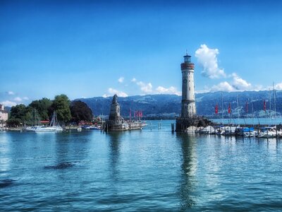 Lighthouse mountains boats photo