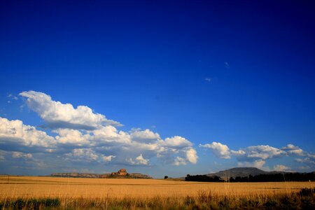 Big blue sky white clouds far off mountains photo