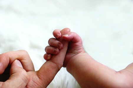 Baby parent hand finger photo