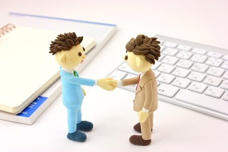 Business men handshake dolls