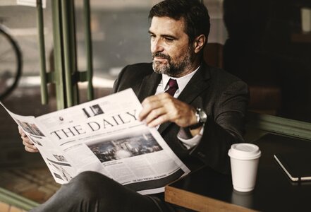 Businessman reading newspaper