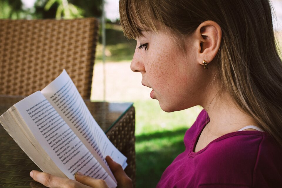 Child girl reading book