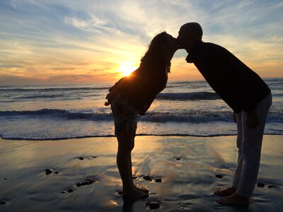 Couple kiss beach sunset photo