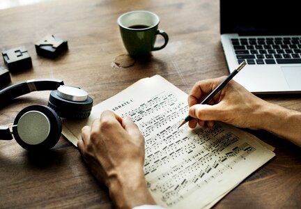 Musical score writing hands photo
