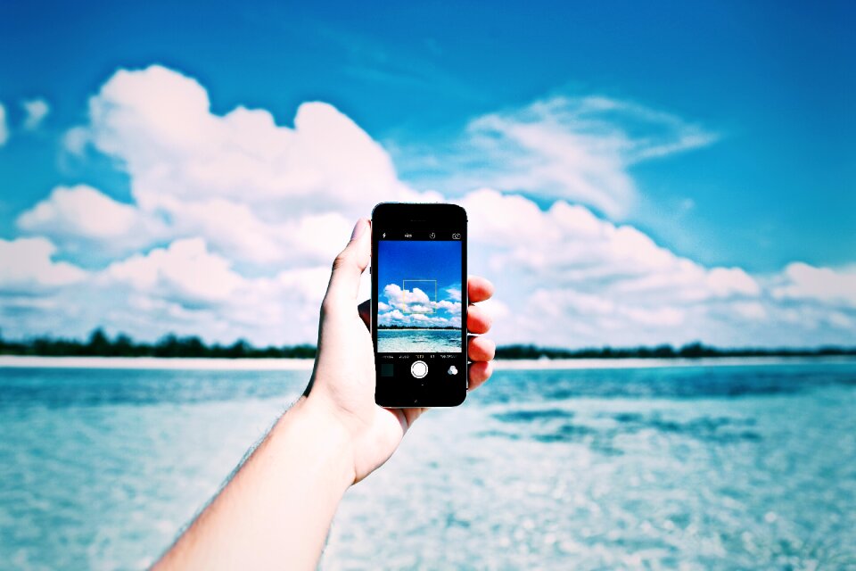Smartphone taking picture sea