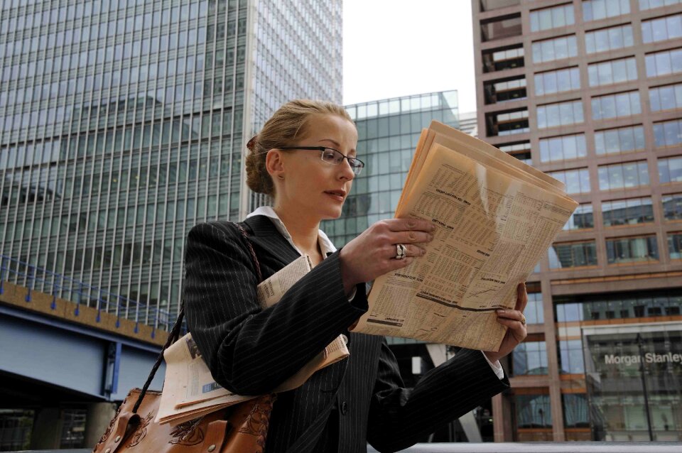 Business woman reading newspaper