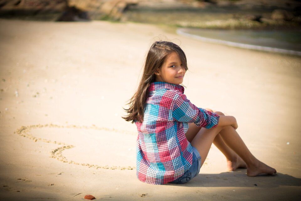 Child girl sitting beach