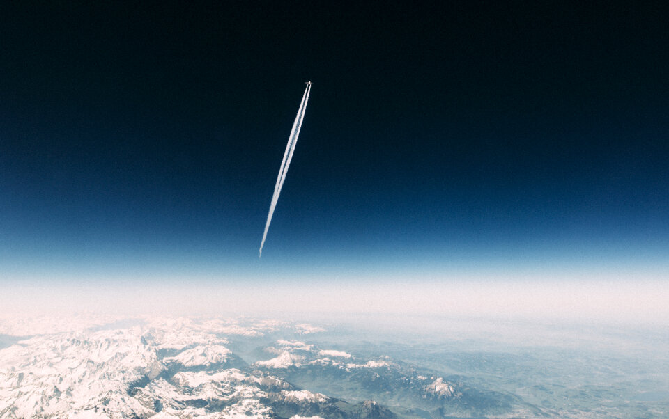 Contrail sky mountains photo