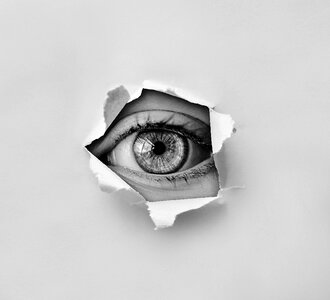 Eye paper hole looking photo